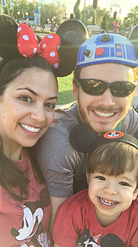 Picture showing Estefi, Jon and Benji smiling with the Disney castle in the background